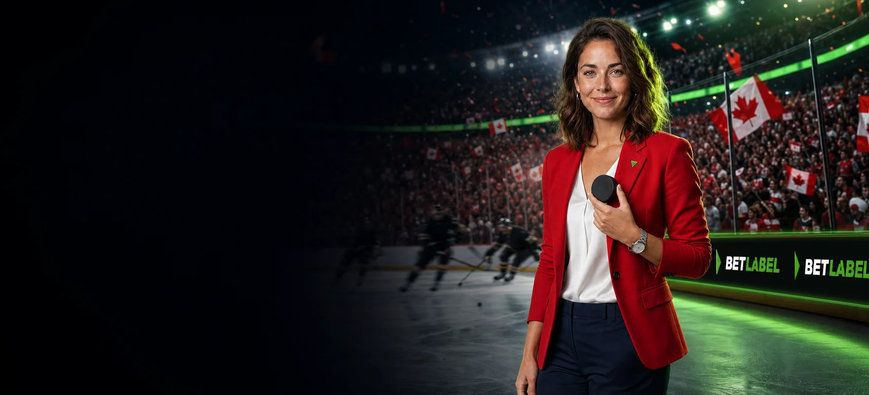 Woman in a red blazer holding a hockey puck by the boards of a packed ice hockey arena, with the BetLabel logo on the LED rink boards
